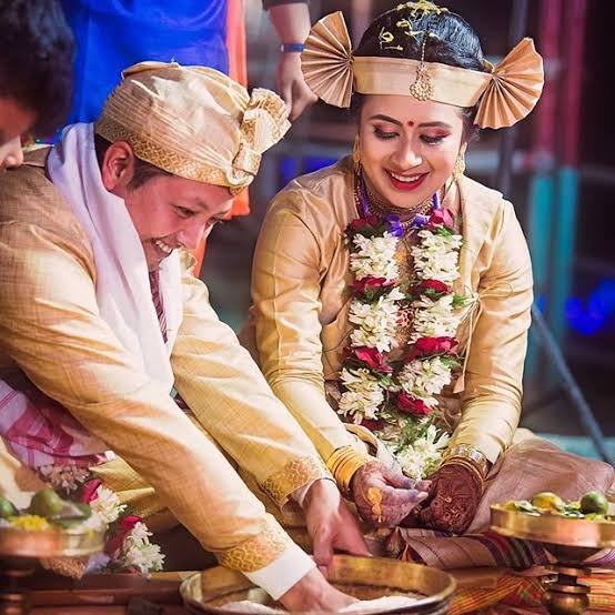 Ahom bride and groom in their wedding apparel of muga silk
