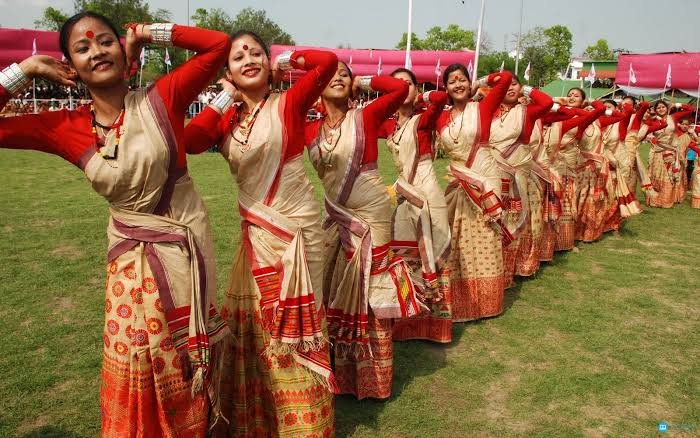 Assamese bihu dancers wearing muga mekhela and muga reeha